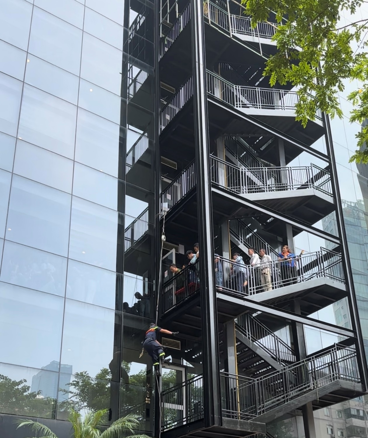 A group of people climbing up a building

Description automatically generated