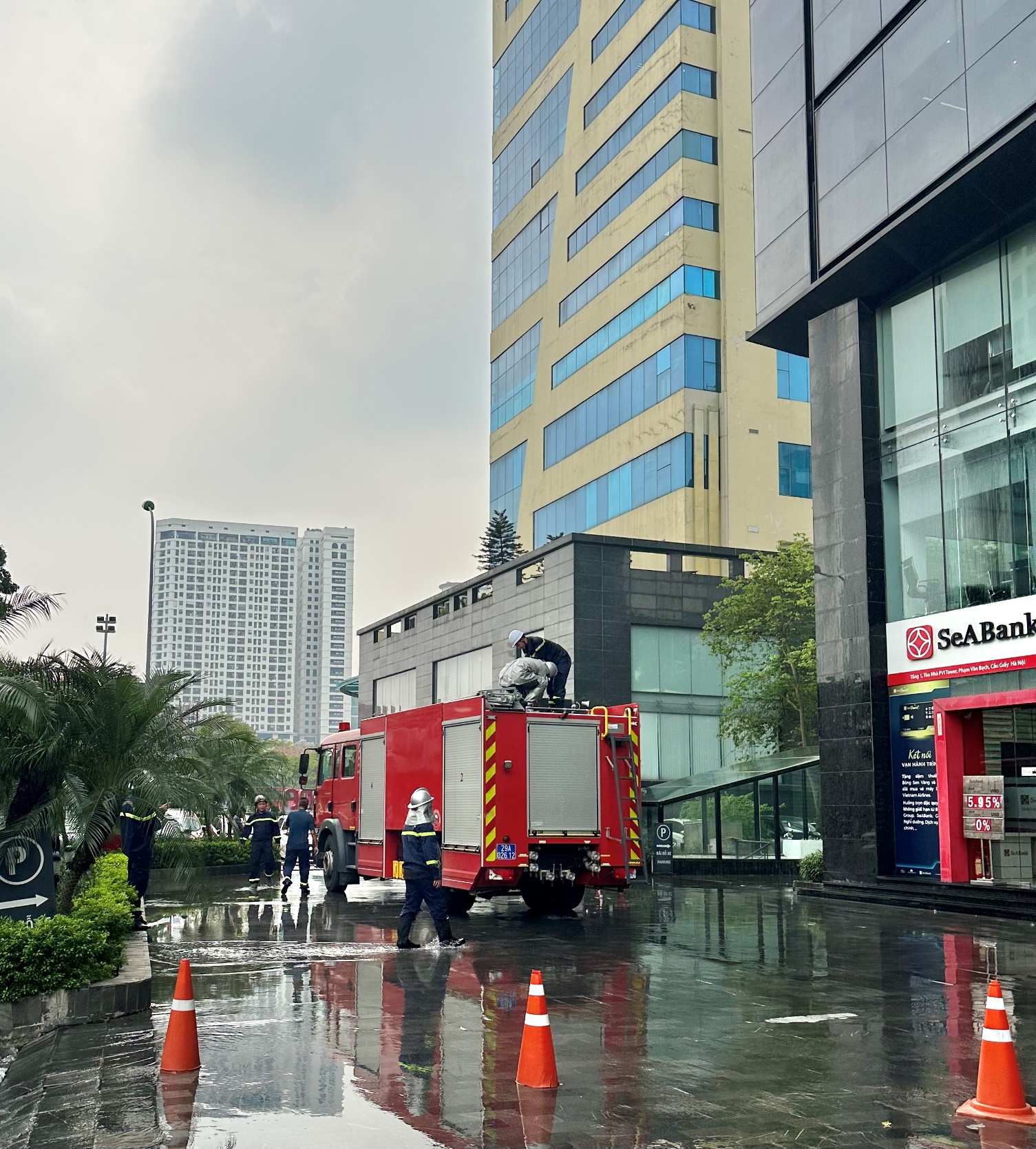 A fire truck parked on a wet street

Description automatically generated